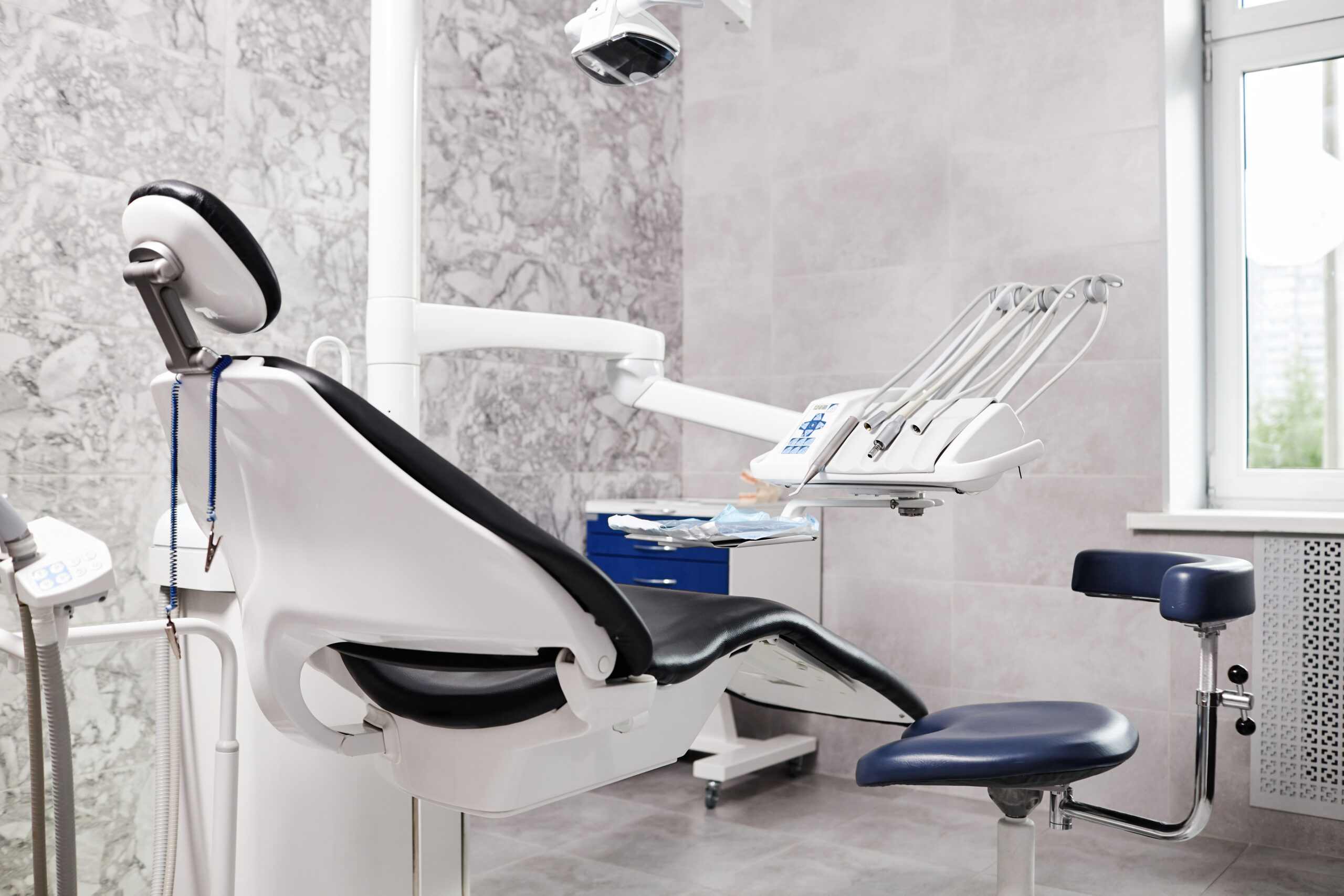 Back view at empty dental chair in modern dentists office Modern Dental OP
